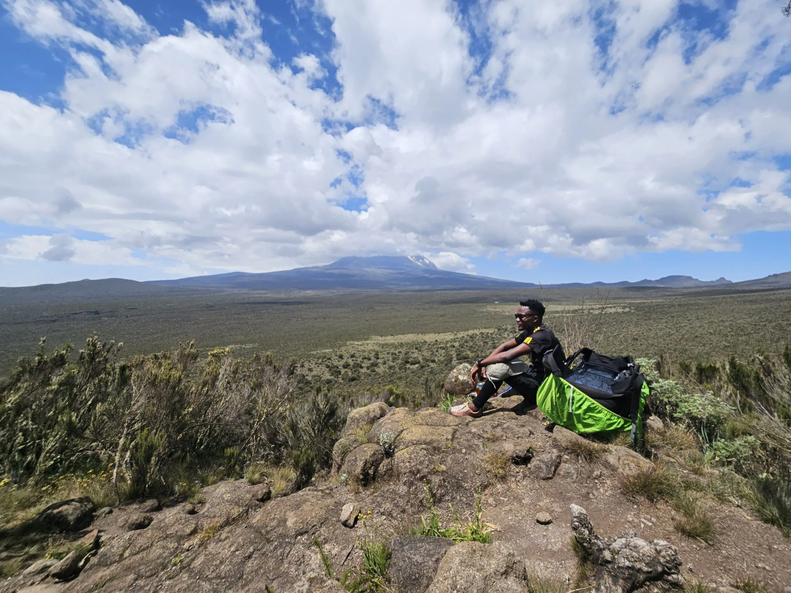 A guide looking out over the plains toward Mount Kilimanjaro