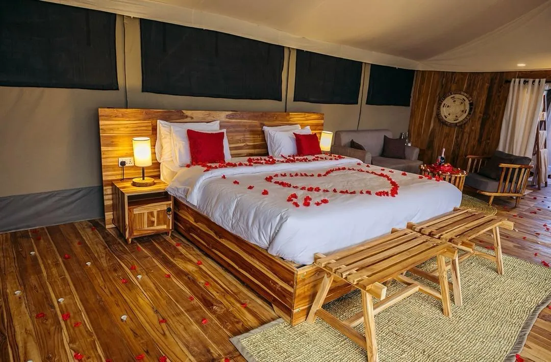 A spacious safari tent bedroom with a large bed